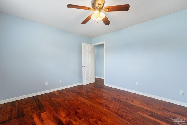 spare room with ceiling fan and dark hardwood / wood-style flooring