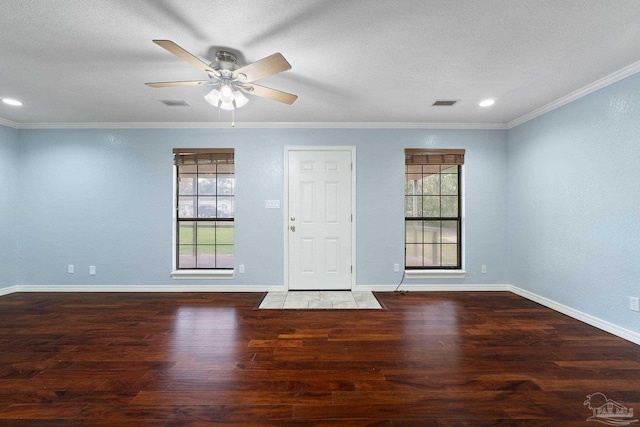 empty room featuring dark hardwood / wood-style floors, ceiling fan, and ornamental molding