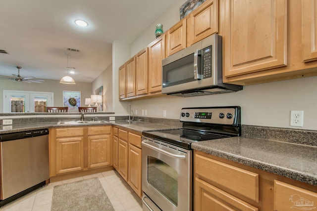 kitchen featuring ceiling fan, sink, french doors, light tile patterned flooring, and appliances with stainless steel finishes