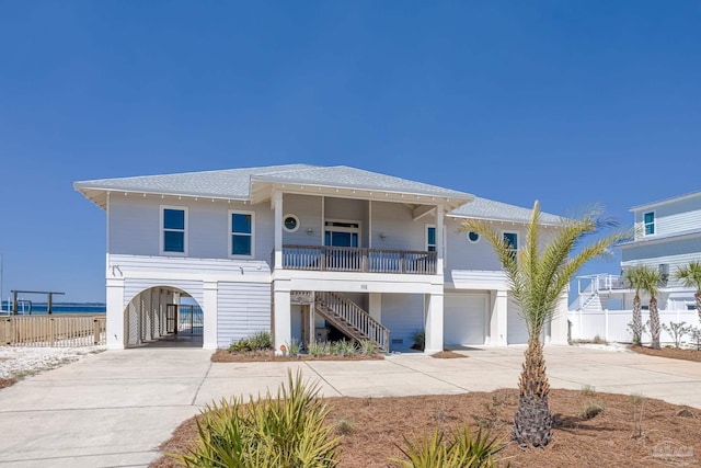 view of front of home featuring a water view, a carport, and covered porch