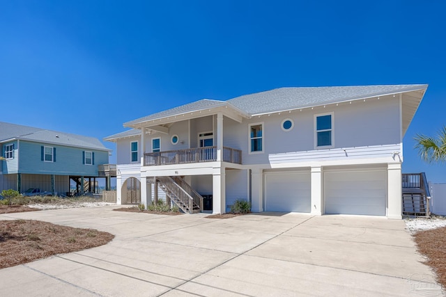 coastal home featuring a garage and covered porch