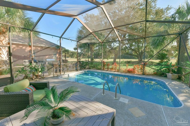 pool with a patio area and glass enclosure