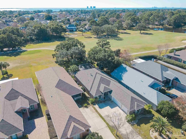 drone / aerial view featuring view of golf course, a water view, and a residential view
