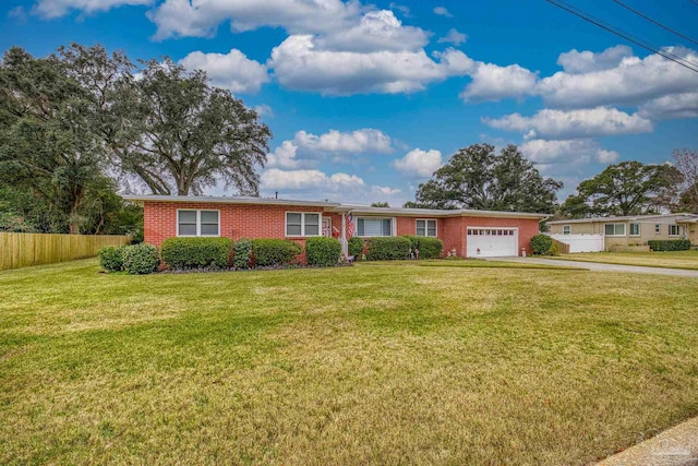 ranch-style home featuring a garage and a front lawn