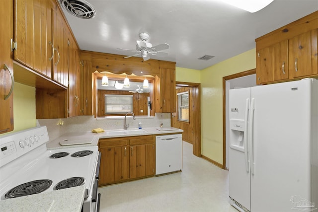 kitchen featuring backsplash, ceiling fan, white appliances, and sink