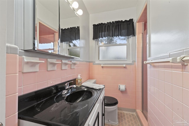 bathroom with vanity, tile patterned flooring, toilet, tile walls, and walk in shower