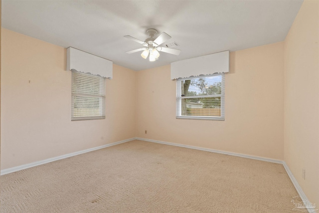 spare room featuring carpet and ceiling fan