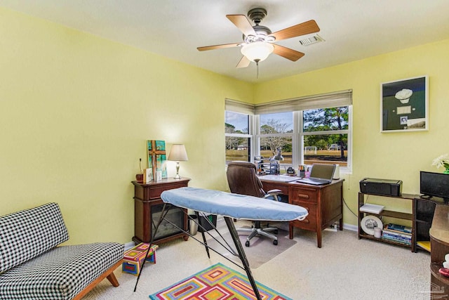 office space featuring ceiling fan and light carpet