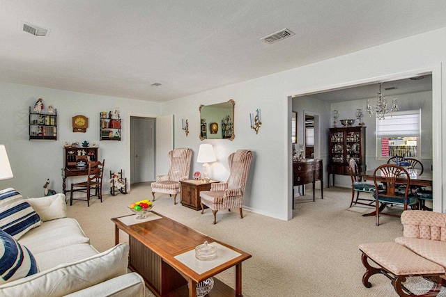 carpeted living room featuring a chandelier