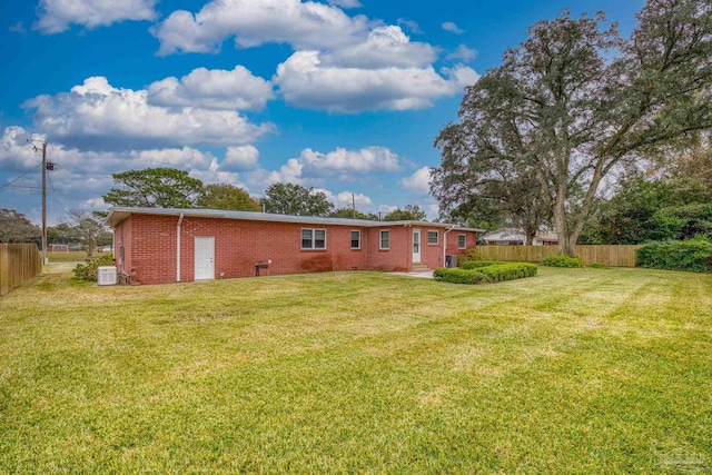 exterior space featuring central AC unit and a yard