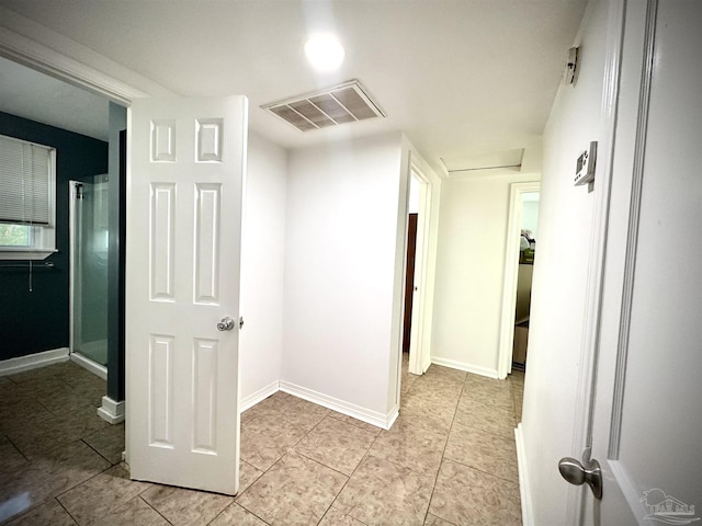 corridor featuring light tile patterned flooring