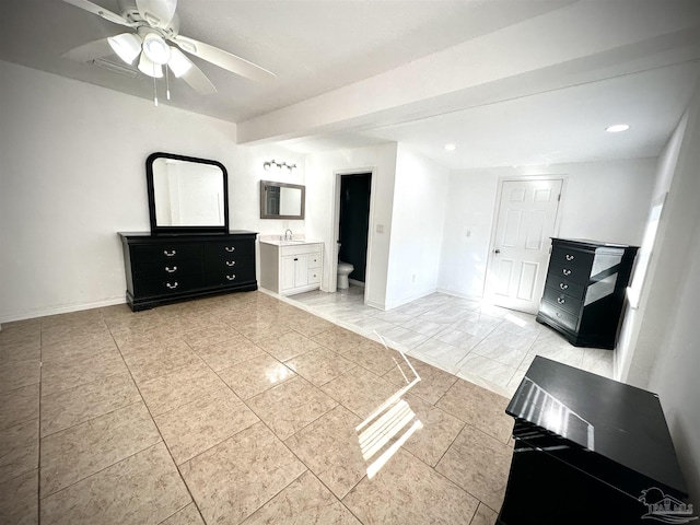 unfurnished bedroom featuring connected bathroom, ceiling fan, and sink