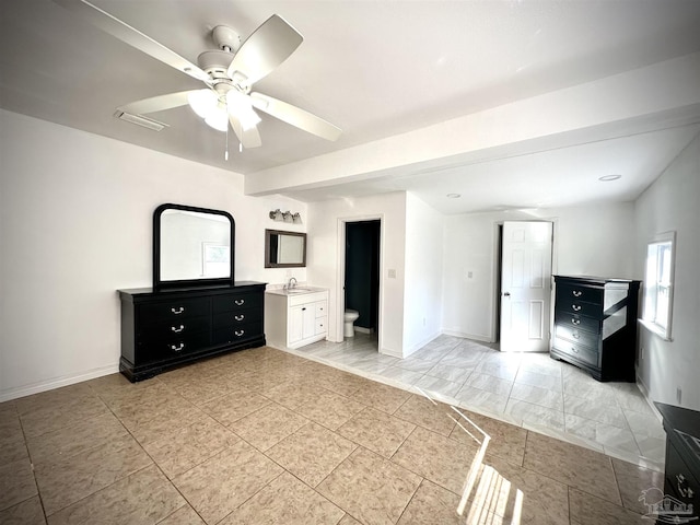 unfurnished bedroom with ensuite bathroom, ceiling fan, and sink