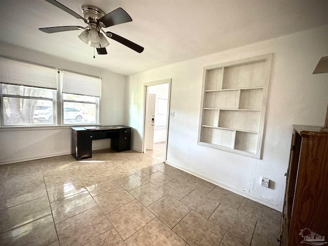 tiled spare room featuring built in features and ceiling fan