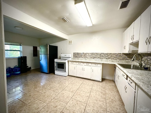 kitchen featuring decorative backsplash, sink, white electric stove, white cabinetry, and stainless steel refrigerator