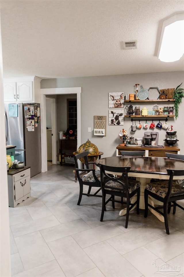 dining area with a textured ceiling