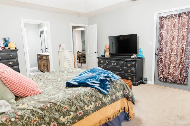 carpeted bedroom featuring ensuite bath