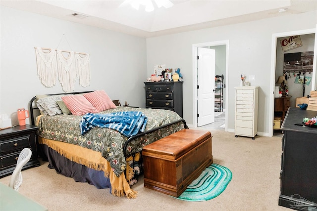 bedroom with light colored carpet, ceiling fan, and a closet