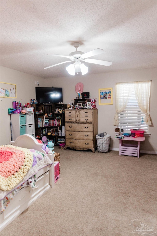 bedroom featuring carpet, a textured ceiling, and ceiling fan