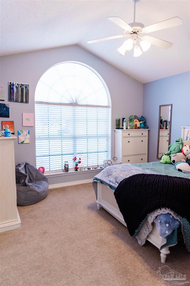 bedroom featuring lofted ceiling, ceiling fan, and carpet flooring