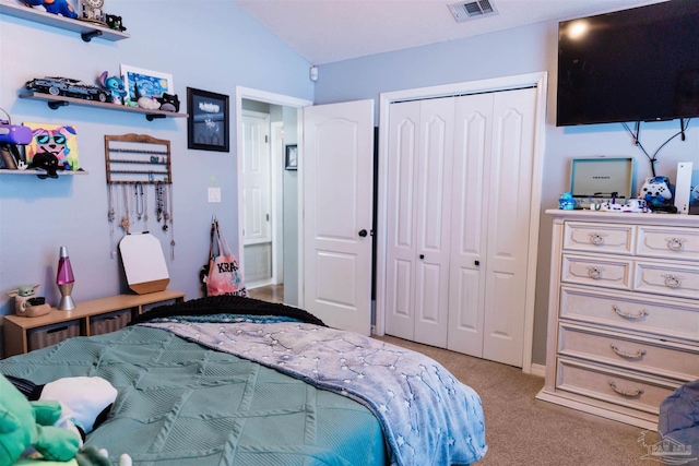 carpeted bedroom featuring lofted ceiling and a closet