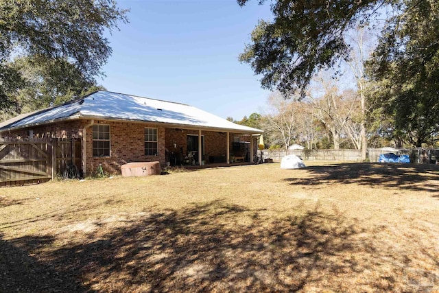 rear view of property featuring a yard