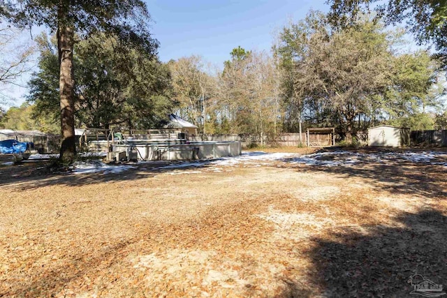 view of yard with a storage unit