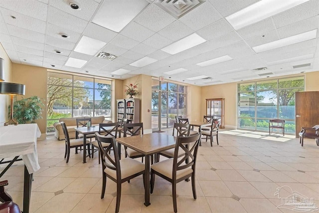 1700 Scenic Hwy Unit 404, Pensacola, FL 32503 - dining area with a paneled ceiling, healthy amount of natural light, light tile patterned flooring, and baseboards