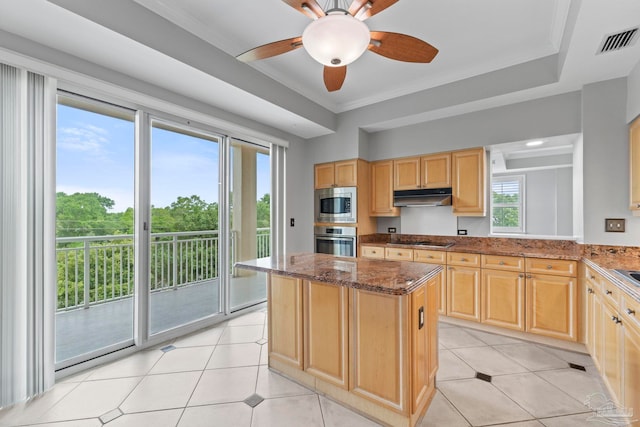 1700 Scenic Hwy Unit 404, Pensacola, FL 32503 - kitchen featuring appliances with stainless steel finishes, light brown cabinetry, under cabinet range hood, dark stone countertops, and ornamental molding