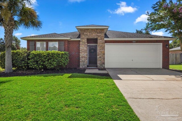 single story home featuring a garage and a front yard