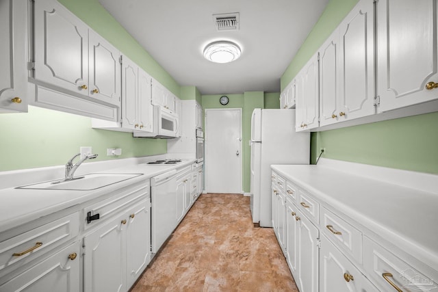 kitchen with white appliances, visible vents, white cabinets, light countertops, and a sink