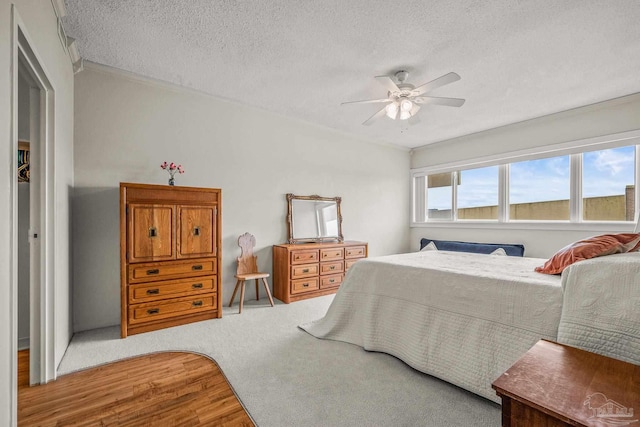 bedroom with a textured ceiling and a ceiling fan