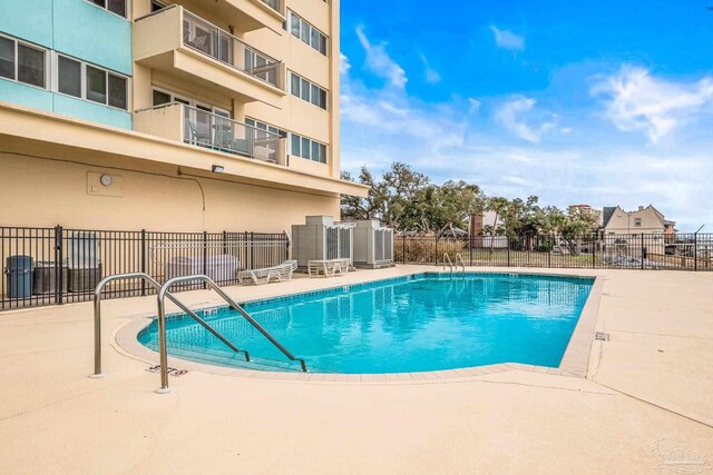 pool with fence and a patio