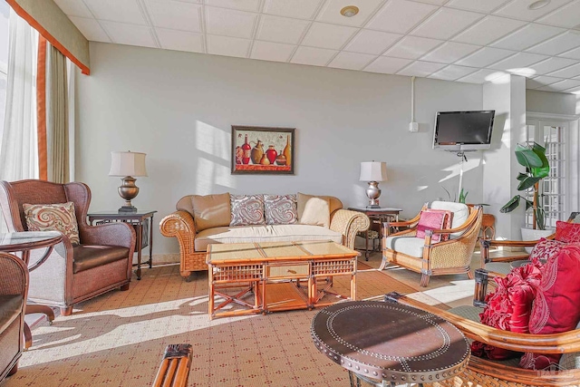 living room with a paneled ceiling