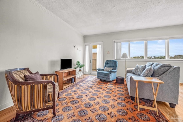 living room with ornamental molding, a textured ceiling, and wood finished floors