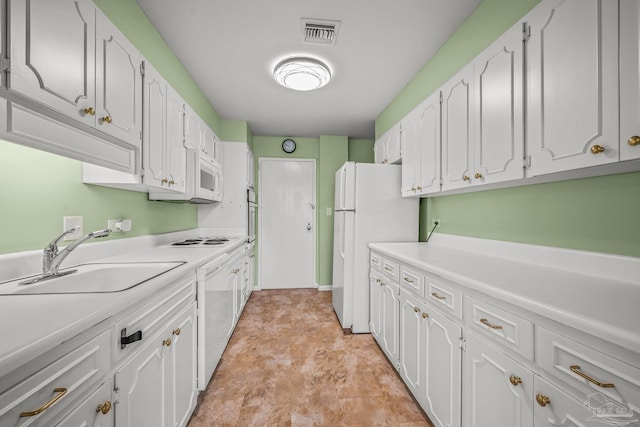 kitchen featuring light countertops, visible vents, white cabinets, a sink, and white appliances