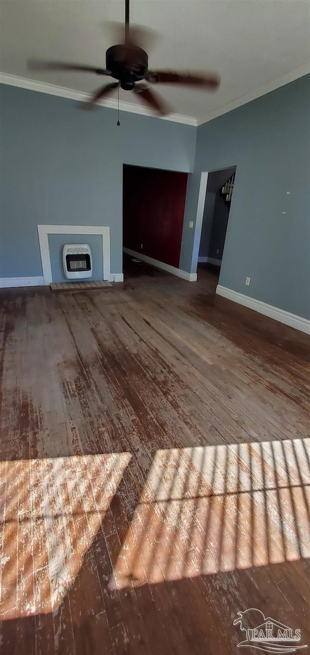 unfurnished living room featuring wood-type flooring, heating unit, and crown molding