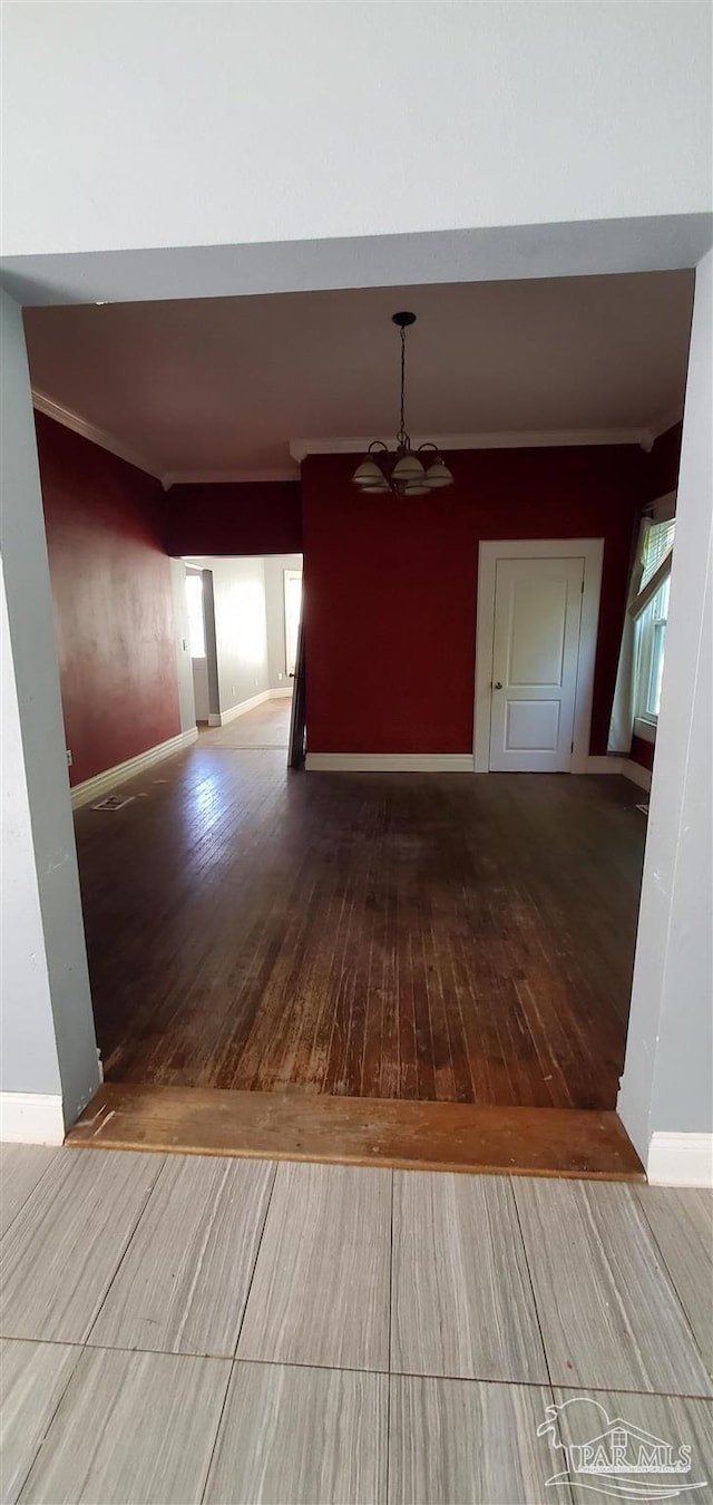 corridor featuring hardwood / wood-style floors and a chandelier