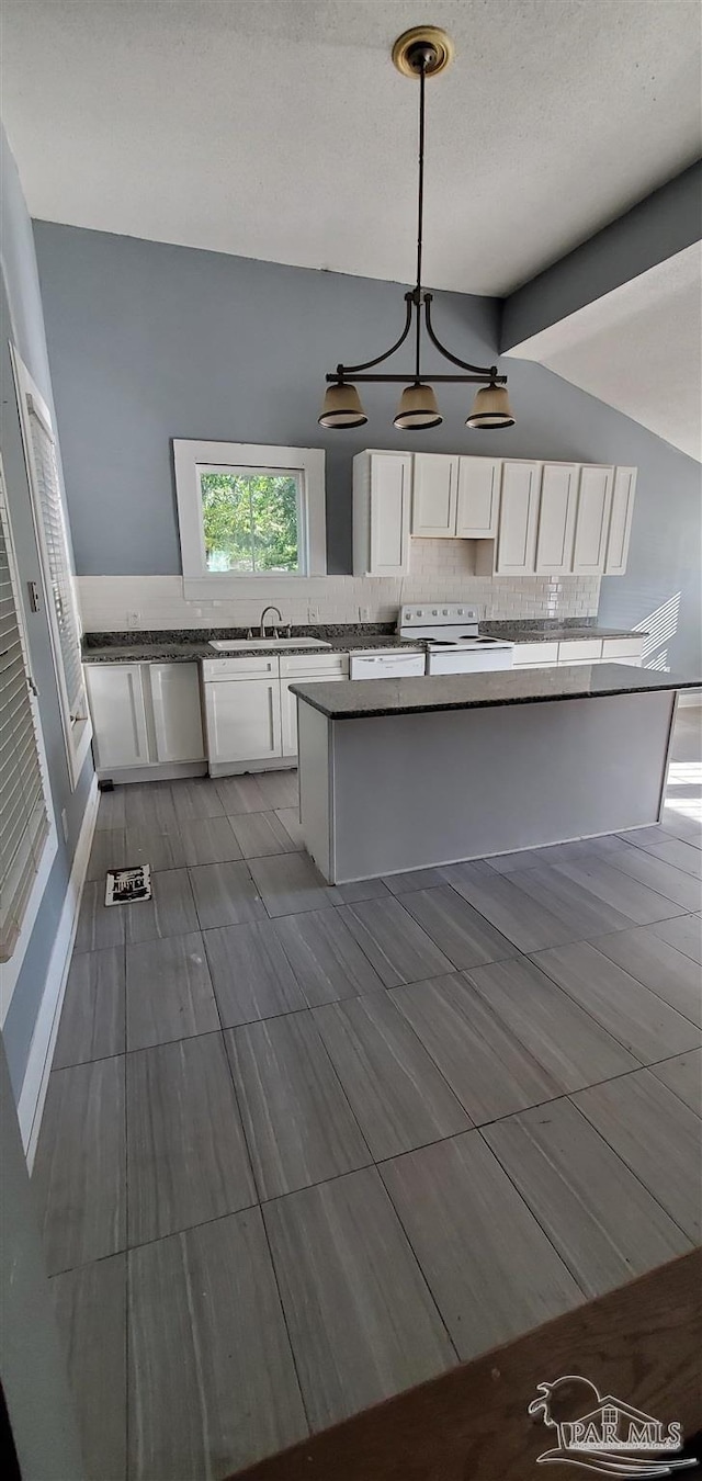 kitchen featuring white electric range oven, lofted ceiling with beams, pendant lighting, white cabinets, and tasteful backsplash