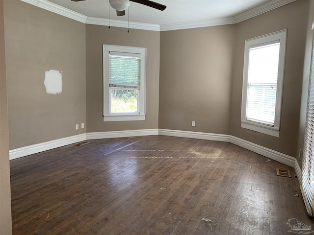 spare room with dark wood-type flooring, ceiling fan, crown molding, and plenty of natural light