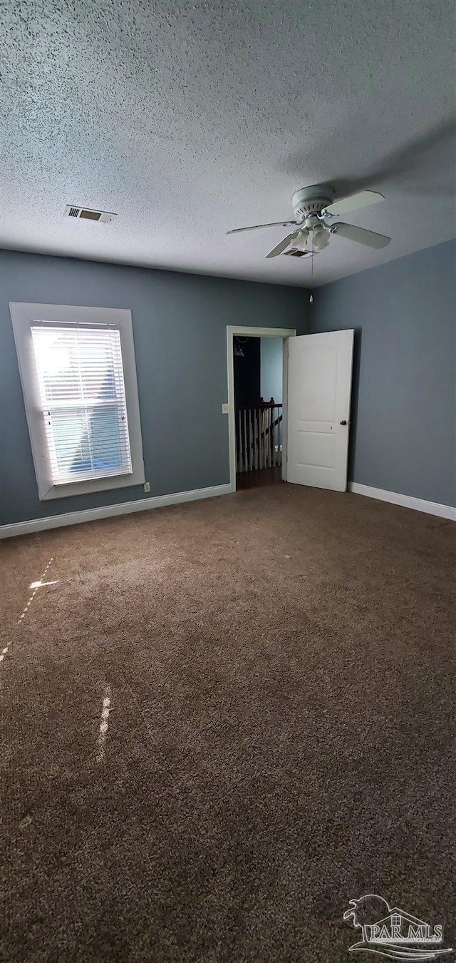 unfurnished room featuring a textured ceiling and ceiling fan