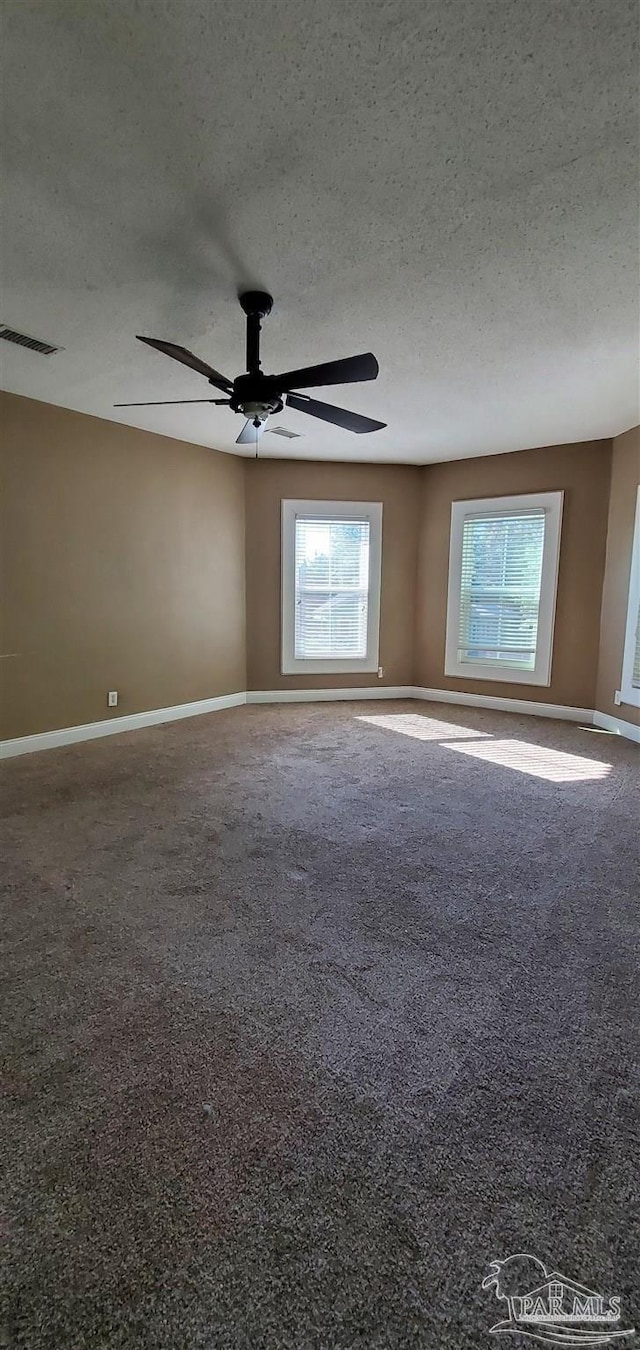 empty room featuring a textured ceiling and ceiling fan