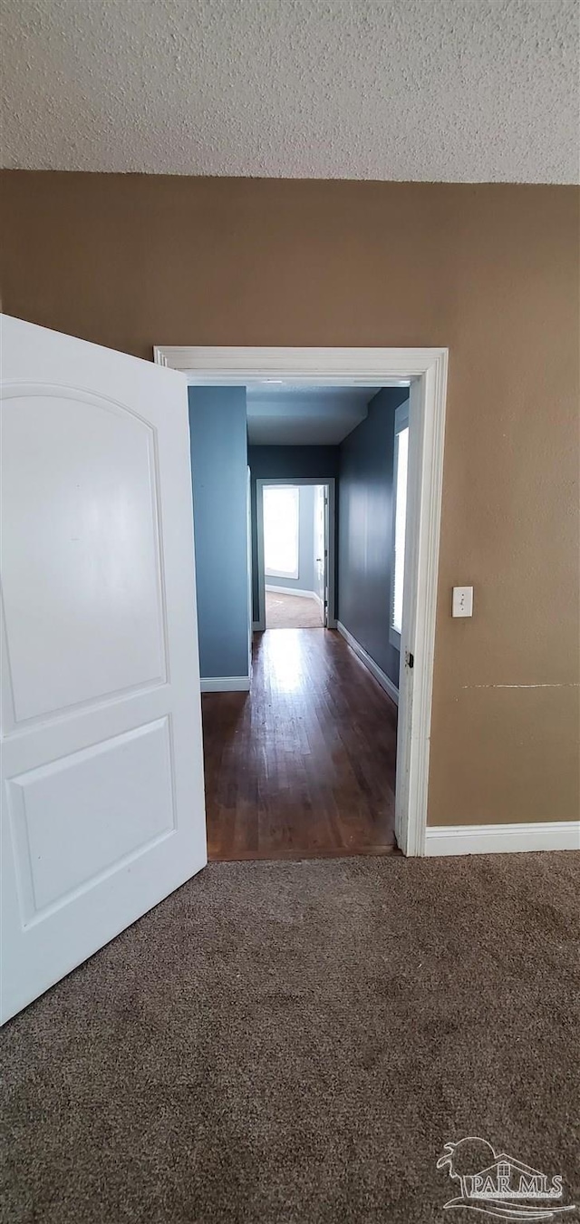 hall with a textured ceiling