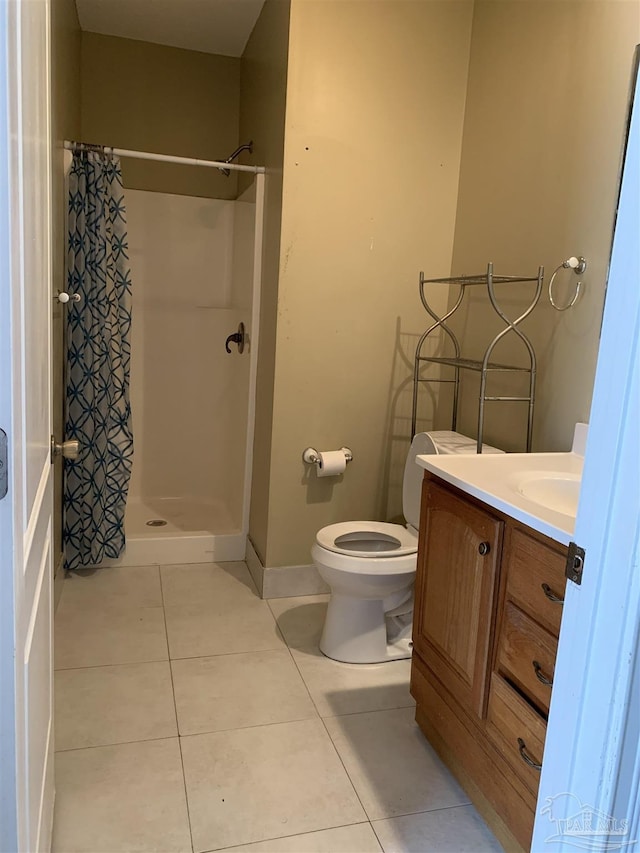 bathroom featuring curtained shower, toilet, vanity, and tile patterned floors