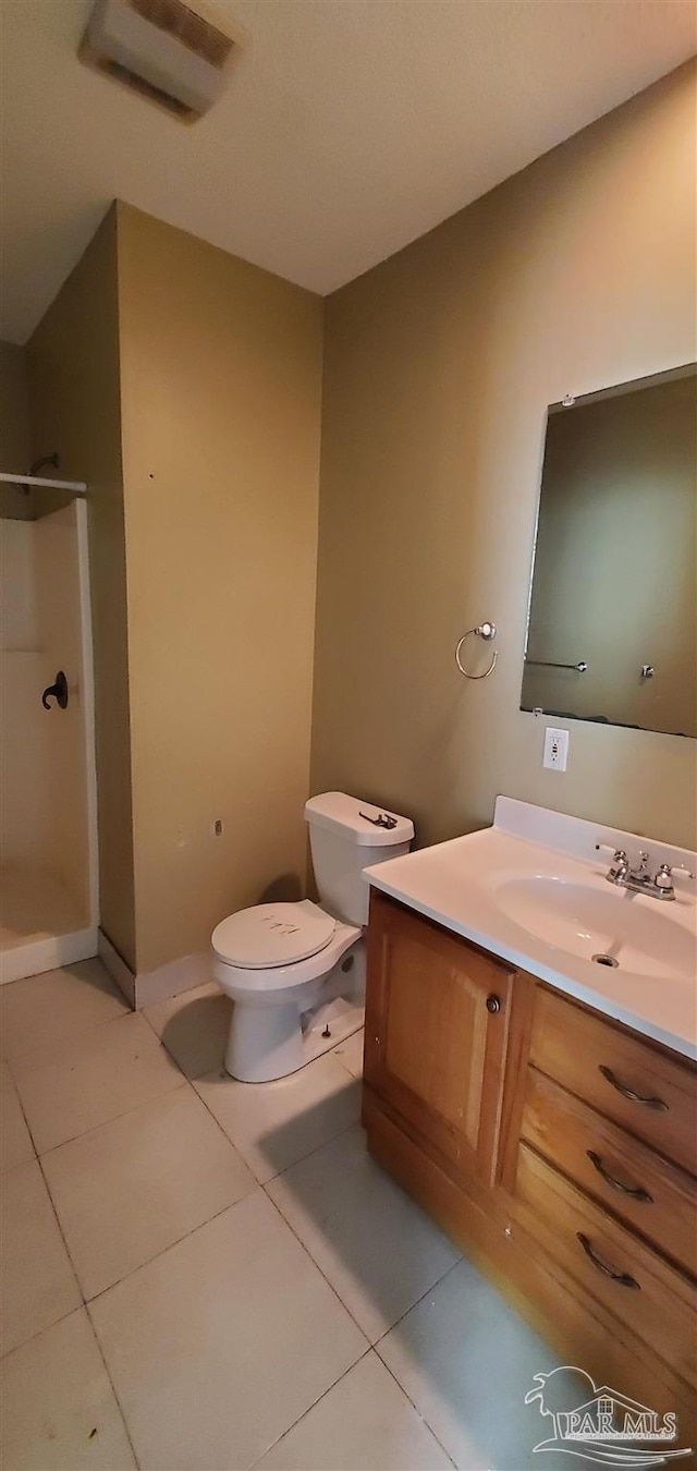 bathroom with toilet, tile patterned floors, walk in shower, and vanity