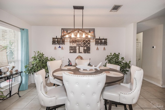 dining space featuring visible vents, baseboards, a notable chandelier, and light tile patterned flooring