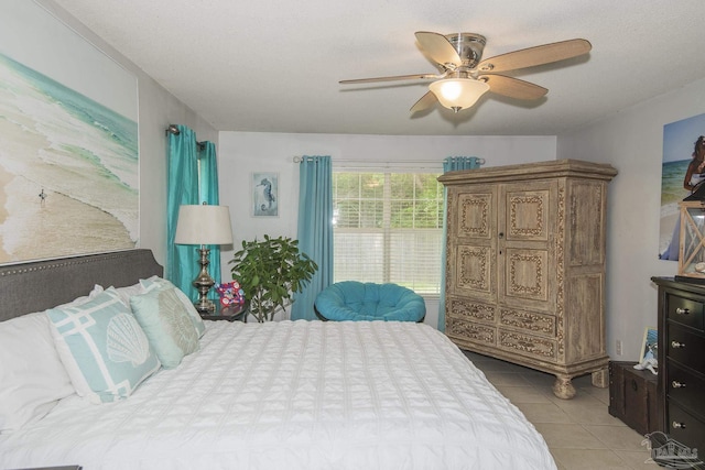 bedroom with a ceiling fan and light tile patterned floors