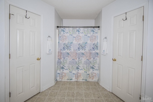 full bathroom featuring baseboards, tile patterned floors, and a shower with curtain