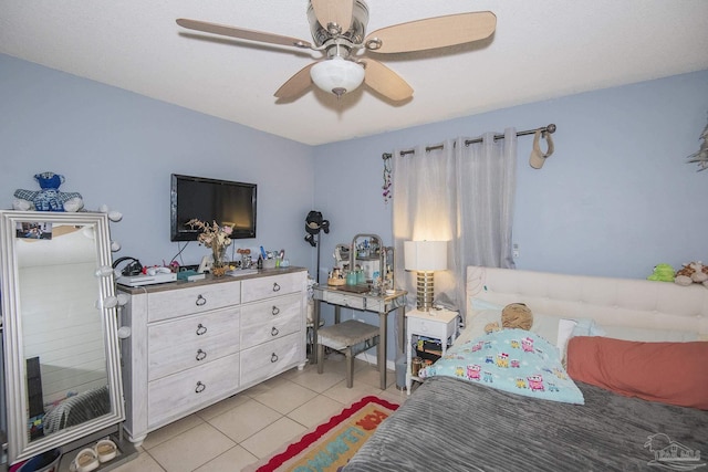 bedroom with ceiling fan and light tile patterned floors