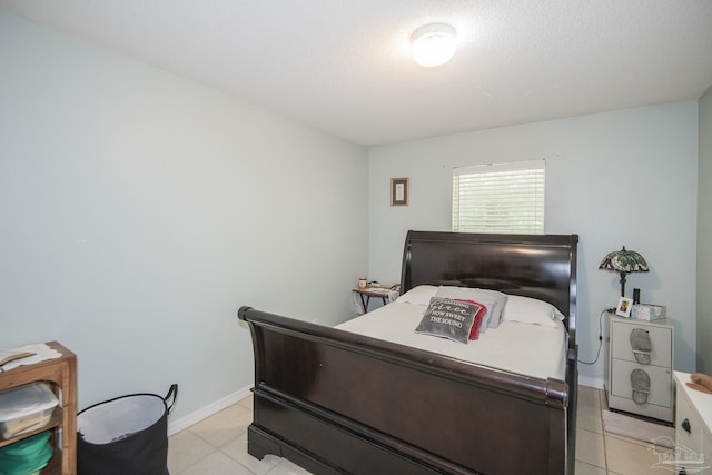 bedroom featuring baseboards and light tile patterned floors